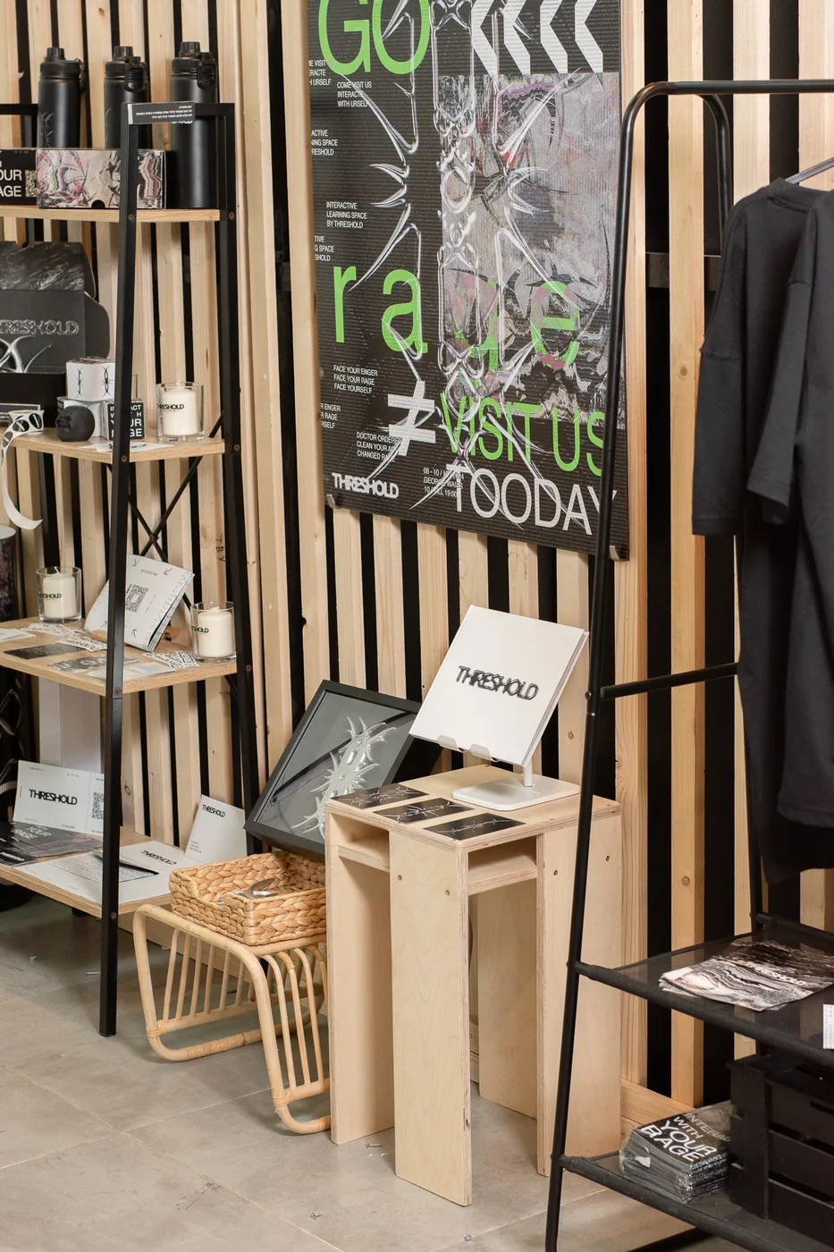 The Threshold shop shelf at the exhibition, RAGE wall behind